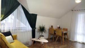 sala de estar con sofá amarillo y mesa en GONTA cottage-окремий котедж з балконом,тераса вигляд на гори, en Slavske