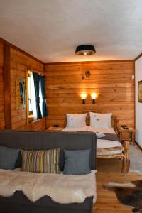 ein Schlafzimmer mit zwei Betten und einem Sofa darin in der Unterkunft Hotel Rajska Vrata in Jahorina