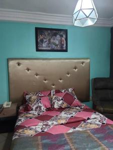 a bedroom with a bed with a quilt on it at Eunique Residence in Port Harcourt