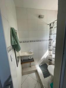 a small bathroom with a sink and a toilet at Renan suítes in Arraial do Cabo