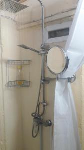 a bathroom with a mirror and a shower curtain at Villa Mukhrovani in Mukhrovani