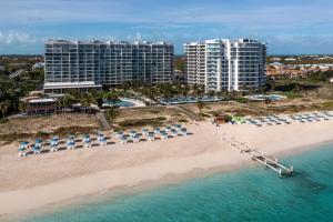 an aerial view of a beach with chairs and umbrellas at The Ritz-Carlton Residences, Turks & Caicos in Providenciales