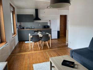 a kitchen and living room with a table and chairs at Appartement Leforest Centre 50m2 in Leforest +7 photos