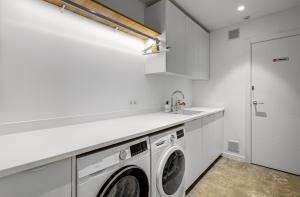a white laundry room with a washer and dryer at Villa Izabele - private heated pool with amazing terrace in Callao Salvaje