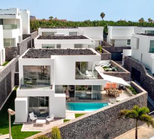 an aerial view of a white apartment building with a swimming pool at Villa Izabele Orange in Callao Salvaje