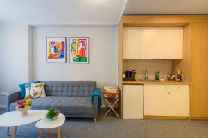 a living room with a couch and a kitchen at LOCATION in Sofia