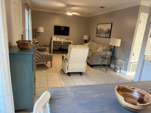 a living room with a couch and a table at 2-Bedroom Condo on Gulf Shores Beach w/Pool in Gulf Shores
