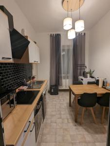 a kitchen with a table and a dining room at Schönes 3 Zimmer Apartment in der Altstadt von Koblenz in Koblenz