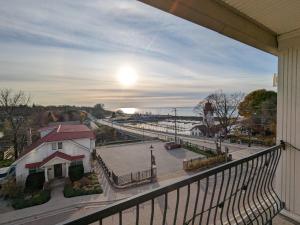a balcony with a view of a street and the ocean at Inn at the Harbour in Kincardine