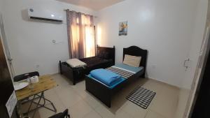a small room with a bed and a couch at ADMBS03 in Abu Dhabi