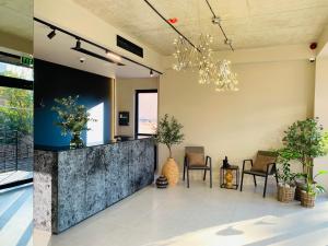 a lobby with a reception desk and potted plants at Doors Hotel in Tbilisi City