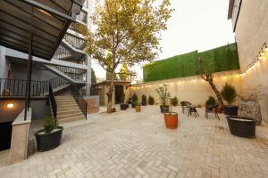 a courtyard with potted plants and stairs in a building at Doors Hotel in Tbilisi City