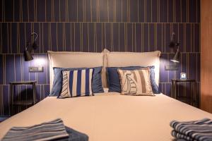 a bedroom with a large bed with blue walls at Apartament PrzystańTu Relax&Spa in Dziwnów