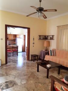 a living room with a couch and a table at Sunny House in Vathí