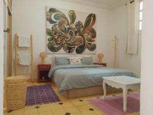 una camera da letto con un letto e un dipinto sul muro di Villa brek a Marrakech