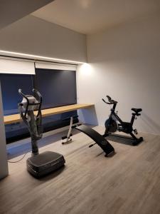 a room with a desk and two exercise bikes at the black line house in Olot