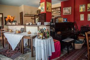 a dining room with a table and a piano at Petradi 1873 in Kalarrites