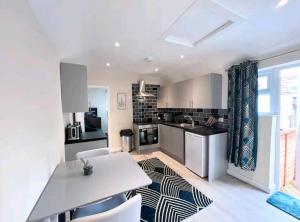 a kitchen with a table and chairs in a room at Taunton Flats in Taunton