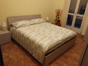 a large bed in a bedroom with two pillows on it at La Villetta a Cuneo in Cuneo