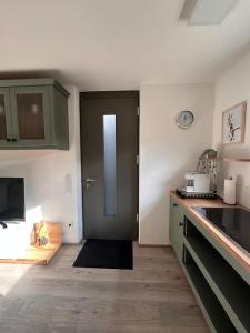 a kitchen with a door in the middle of a room at Liebevoll und gemütlich! in Meßkirch