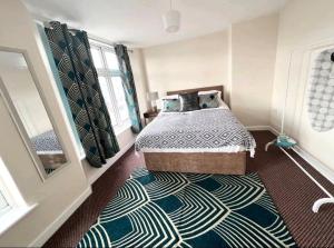a bedroom with a bed and a rug at Taunton Flats in Taunton