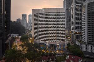 a large building in the middle of a city at Four Points by Sheraton Kuala Lumpur, City Centre in Kuala Lumpur