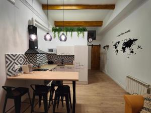 a kitchen with a wooden table and chairs at Apartamentos Santander 1 in Santander