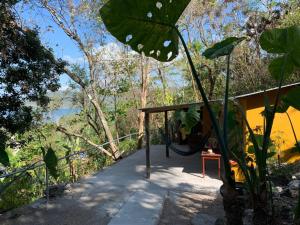 a tree house with a swing in the woods at Casa Alemán in Flores
