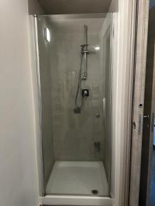 a shower with a glass door in a bathroom at IL GIARDINETTO DI ELELU' Private Garage in Orvieto +36 photos