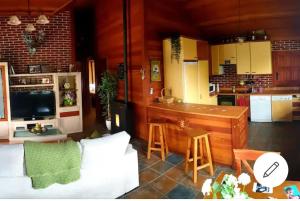 a kitchen and living room with a counter and a kitchen and a counter at "Pequeño Paraiso" Cabaña con Jacuzzi y piscina privada in Traspinedo