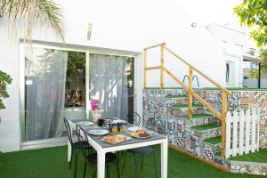 a white table with some food on it on a patio at Villa Loria in San Vito lo Capo