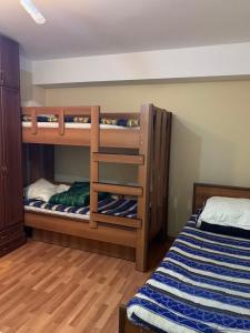 two bunk beds in a room with a bed at axis in Kʼumlistsʼikhe