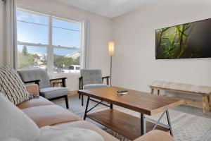 a living room with a couch and a table at Butler Beach Bliss Modern Beach Vacation Home in Saint Augustine