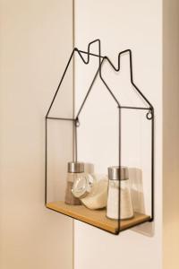 a glass shelf on a wall with items on it at Ultra central apartment in Baia Mare