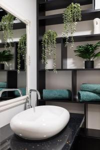 a bathroom with a white sink and a mirror at Ultra central apartment in Baia Mare +7 photos