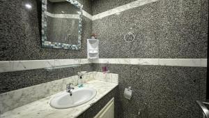 a bathroom with a sink and a mirror at Appartement Slim centre sousse in Sousse +21 photos