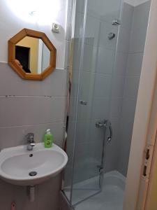 a bathroom with a shower and a sink and a mirror at Willa Dniestrzanka in Krynica Zdrój