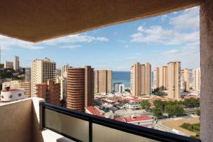 a balcony with a view of a city at Dynastic Rooms Apartments in Benidorm
