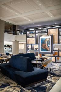 a living room with a blue couch and tables at Chicago Marriott Downtown Magnificent Mile in Chicago