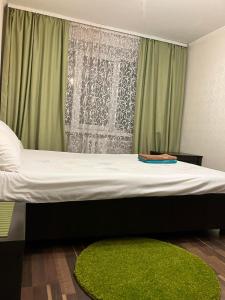 uma cama num quarto com uma cortina verde em Elena em Rivne