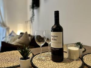 a bottle of wine and a glass on a table at Kings Cross City Apartment in London