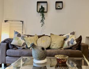 a living room with a couch and a glass table at Kings Cross City Apartment in London