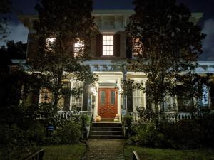 a white house with a red door at night at The Craft House in Wilmington