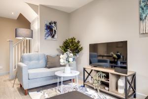 a living room with a couch and a tv at MK 2-Bedroom Contractor's Gem, 5 beds, sleeps 6, free parking in Milton Keynes