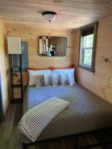a bedroom with a bed in a log cabin at Red River Gorge Couples and Climbing getaway in Prime Location! in Campton