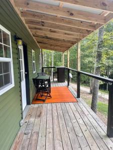 a porch of a house with a table and a bench at Red River Gorge Couples and Climbing getaway in Prime Location! in Campton