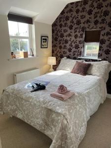 a bedroom with a bed with towels on it at Burton Hall - Pauline in Carlow