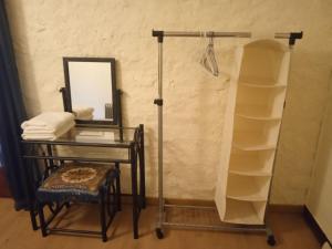 a vanity with a table and a mirror and a shelf at Chambres d'hôtes du Péras in Saint-Jean-du-Gard