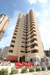 a large building with a large clock on the side of it at Apartamentos Mayra - SABESA in Benidorm