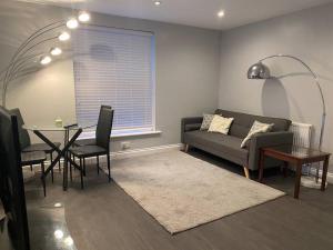 a living room with a couch and a table at Spacious 2 bedroom flat london in London